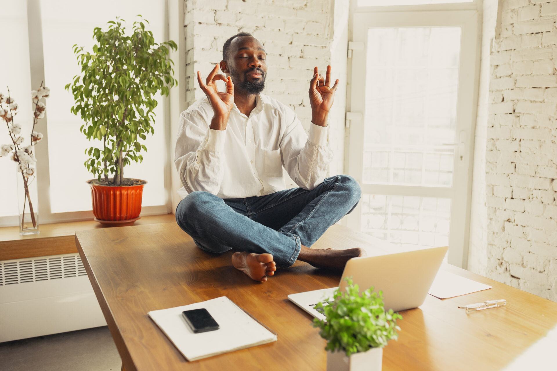 Homme faisant du yoga tout en travaillant